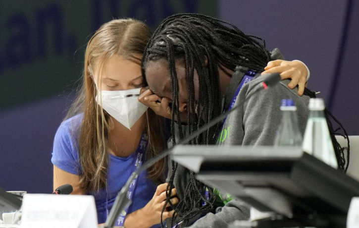 Ugandan climate activist Vanessa Nakate, right, is comforted by Swedish activist Greta Thunberg as she is overcome by emotion after speaking at the opening of a three-day Youth for Climate su