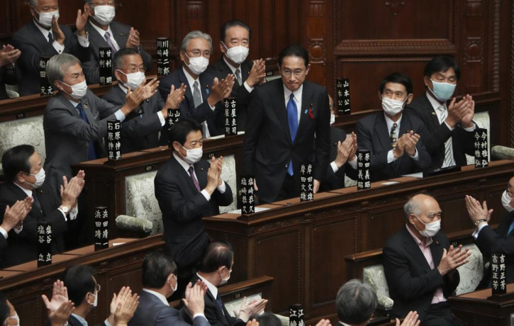 Fumio Kishida, center, is applauded after being elected as Japan's prime minister at the parliament's lower house Monday, Oct. 4, 2021, in Tokyo.
