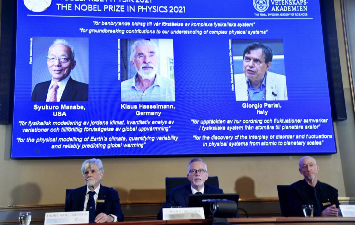 Secretary General of the Royal Swedish Academy of Sciences Goran Hansson, center, announces the winners of the 2021 Nobel Prize in Physics at the Royal Swedish Academy of Sciences, in Stockho