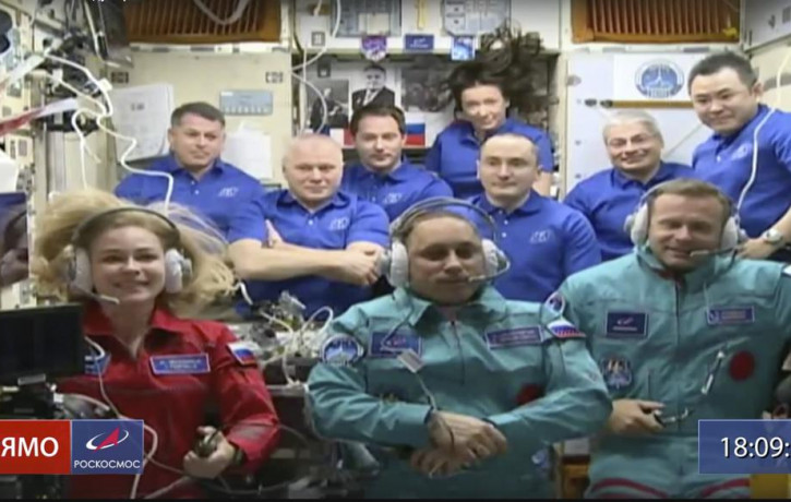 Actress Yulia Peresild, left, film director Klim Shipenko, right, and cosmonaut Anton Shkaplerov sit in the first row among other participants of the mission in the International Space Statio