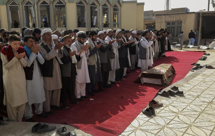 Relatives and residents pray during a funeral ceremony for victims of a suicide attack at the Gozar-e-Sayed Abad Mosque in Kunduz, northern Afghanistan, Saturday, Oct. 9, 2021.
