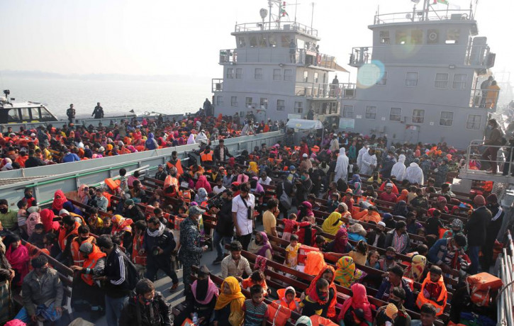 In this Dec. 29, 2020, file photo, Rohingya refugees wait on naval ships to be transported to an isolated island in the Bay of Bengal, in Chittagong, Bangladesh.