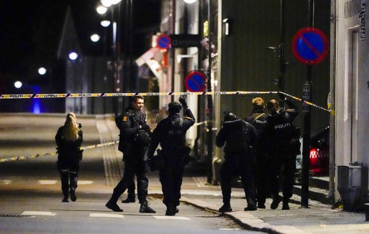 Police stand at the scene after an attack in Kongsberg, Norway, Wednesday, Oct. 13, 2021.
