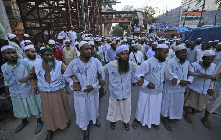 Muslims lock hands during a protest over an alleged insult to Islam, outside the country’s main Baitul Mukarram Mosque in Dhaka, Bangladesh, Saturday, Oct. 16, 2021.
