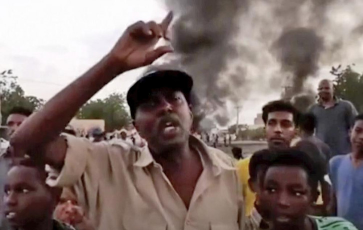In this frame taken from video people gather during a protest in Khartoum, Sudan, Monday, Oct. 25, 2021.