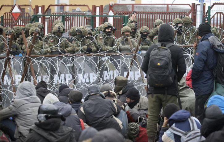 Migrants from the Middle East and elsewhere gather at the checkpoint "Kuznitsa" at the Belarus-Poland border near Grodno, Belarus, on Monday, Nov. 15, 2021.