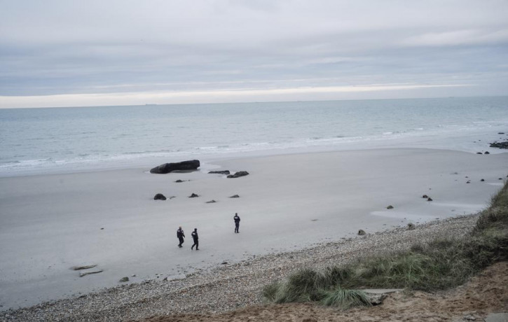 French police officers patrol on the beach in the searcher migrants in Wimereux, northern France, Wednesday, Nov.17, 2021.