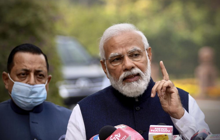 Indian Prime Minister Narendra Modi, addresses the media as he arrives to attend the opening day of the winter session of Parliament in New Delhi, India, Monday, Nov.29, 2021.