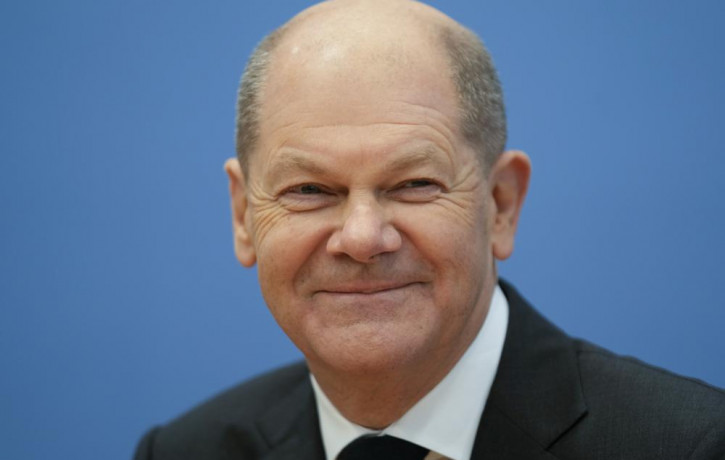 Designated German Chancellor Olaf Scholz smiles during a news conference after the signing of the coalition agreement with two other parties for new German government in Berlin, Germany, Tues