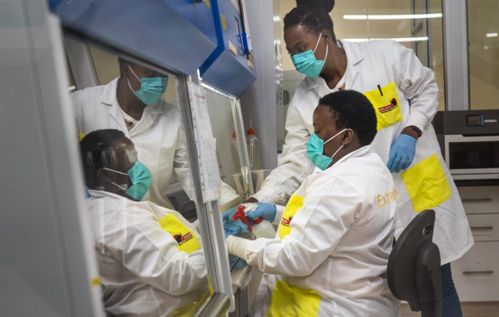 Melva Mlambo, right, and Puseletso Lesofi, both medical scientists prepare to sequence COVID-19 omicron samples at the Ndlovu Research Center in Elandsdoorn, South Africa, Dec. 8, 2021.