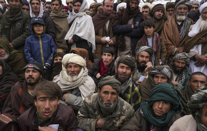 Hundreds of Afghan men gather to apply for the humanitarian aid in Qala-e-Naw, Afghanistan, Tuesday, Dec. 14, 2021.
