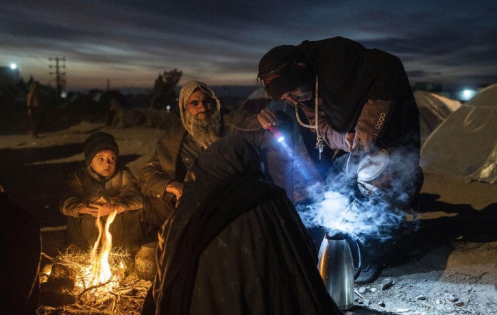 A family prepares tea outside the Directorate of Disaster office where they are camped, in Herat, Afghanistan, on Nov. 29, 2021.