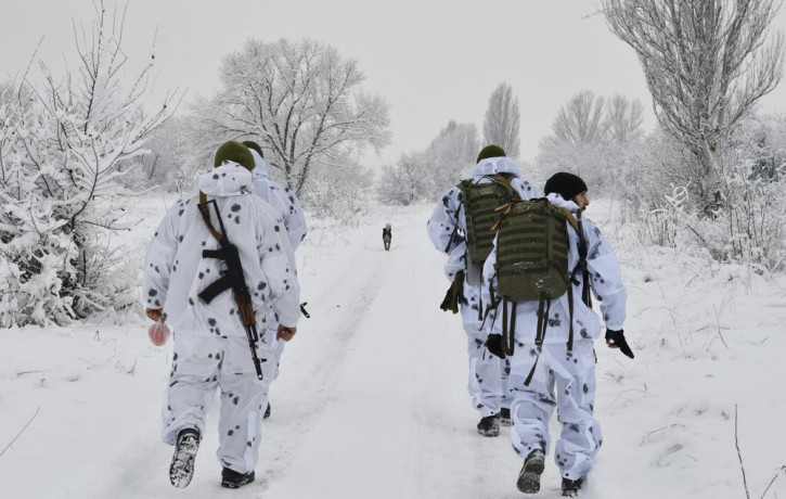 Ukrainian servicemen walk to their position at the frontline with with Russia-backed separatists outside Verkhnotoretske village in Yasynuvata district of Donetsk region, eastern Ukraine, Dec