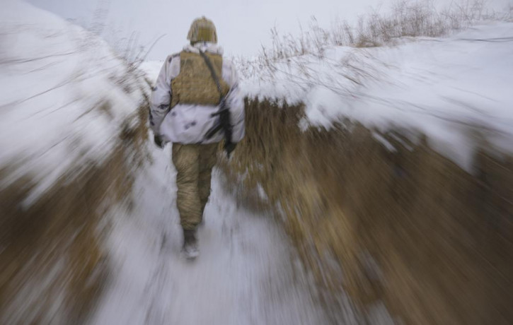 A Ukrainian serviceman walks through a trench on the front line in the Luhansk area, eastern Ukraine, Thursday, Jan. 27, 2022.