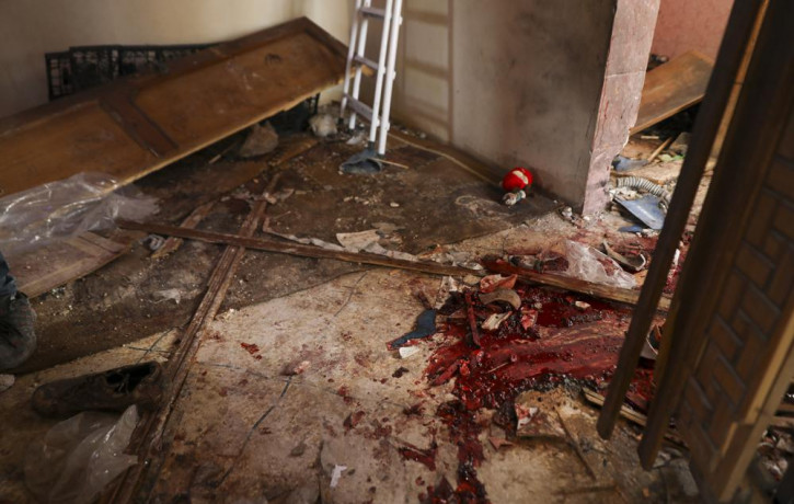 Blood covers the floor of a destroyed house after an operation by the U.S. military in the Syrian village of Atmeh in Idlib province, Syria, Thursday, Feb. 3, 2022.