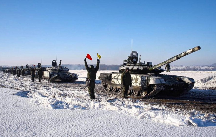 In this photo taken from video provided by the Russian Defense Ministry Press Service on Tuesday, Feb. 15, 2022, Russian army tanks stand ready to move back to their permanent base after dril