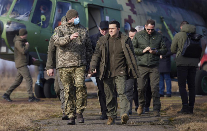 Ukrainian President Volodymyr Zelenskyy, center, arrives to attend a military drill outside the city of Rivne, northern Ukraine, Wednesday, Feb. 16, 2022.