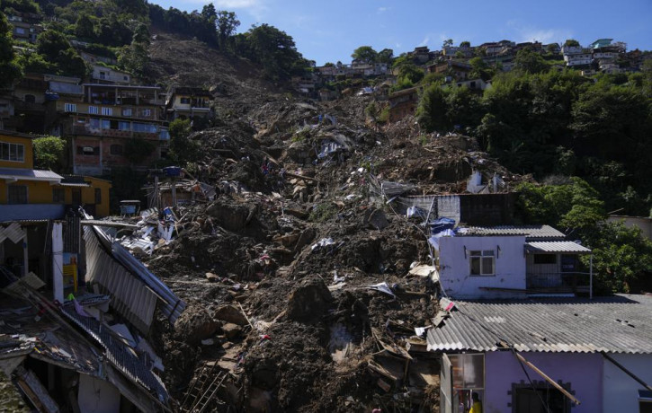 The path of a mudslide marks a hillside filled with homes in Petropolis, Brazil, Thursday, Feb. 17, 2022.