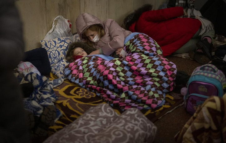 People rest in the Kyiv subway, using it as a bomb shelter in Kyiv, Ukraine, Thursday, Feb. 24, 2022.