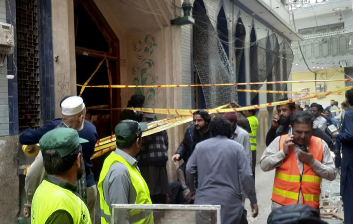 Rescue workers and volunteers gather at the site of bomb explosion in Peshawar, Pakistan, Friday, March 4, 2022.