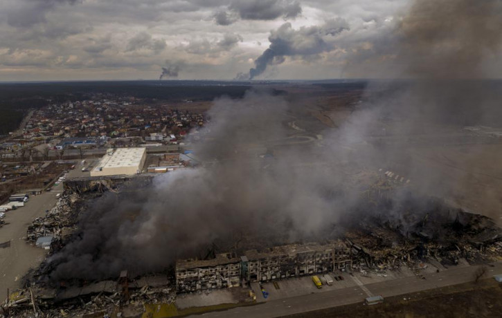 A factory and a store are burning after been bombarded in Irpin, in the outskirts of Kyiv, Ukraine, Sunday, March 6, 2022.