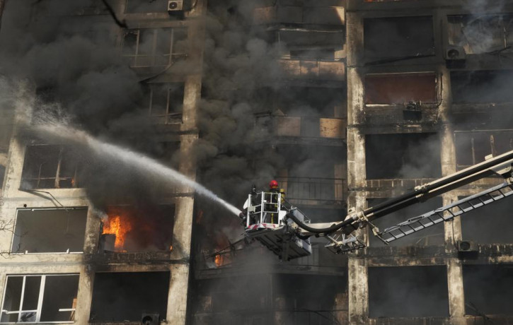 Firefighters work in an apartment building damaged by shelling in Kyiv, Ukraine, Tuesday, March 15, 2022.