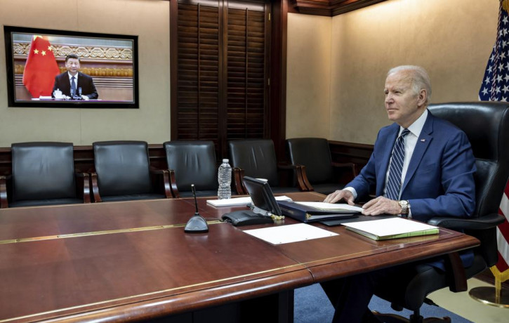 In this image provided by the White House, President Joe Biden meets virtually from the Situation Room at the White House with China’s Xi Jinping, Friday, March 18, 2022, in Washington.