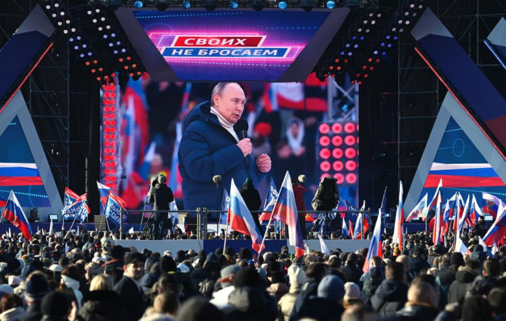 Russian President Vladimir Putin seen on the big screen as he delivers his speech at the concert marking the eighth anniversary of the referendum on the state status of Crimea and Sevastopol 