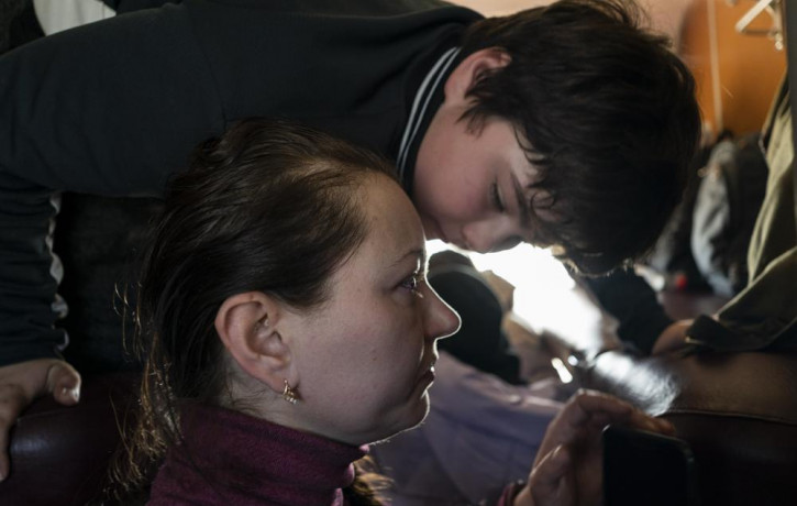 Marina Galla and her son, who both scaped from the besieged city of Mariupol onboard a Zaporizhzhia-Lviv train in western Ukraine, on Sunday, March 20, 2022.