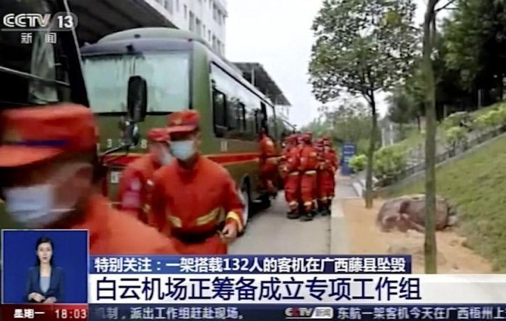 In this image taken from video footage run by China's CCTV, emergency personnel prepare to travel to the site of a plane crash near Wuzhou in southwestern China's Guangxi Zhuang Autonomous Re