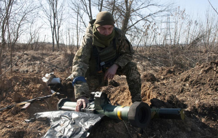 A Ukrainian serviceman guards his position in Kharkiv outskirts, Ukraine, Wednesday, March 23, 2022.