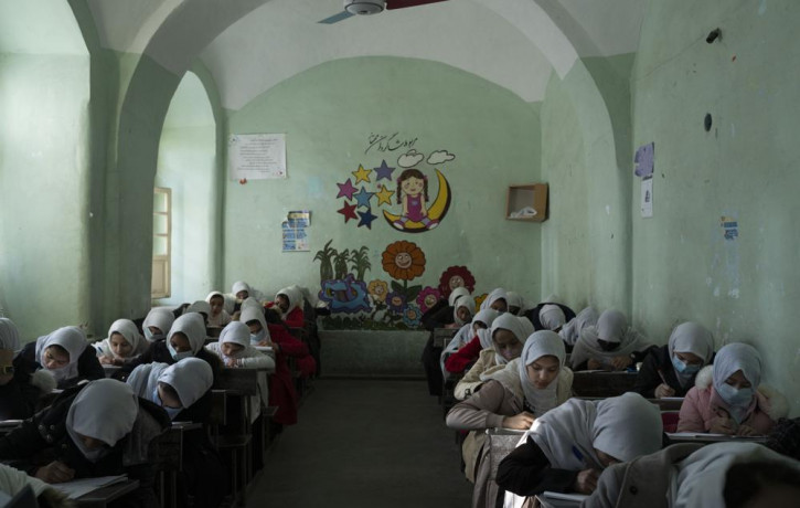 Afghan girls participate a lesson inside a classroom at Tajrobawai Girls High School, in Herat, Afghanistan, Nov. 25, 2021.