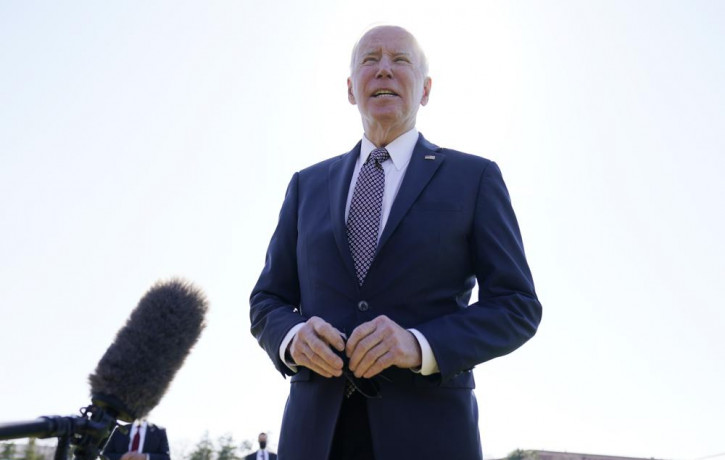 President Joe Biden speaks to the media at Fort Lesley J. McNair, Monday, April 4, 2022, as he returns to Washington and the White House after spending the weekend in Wilmington, Delaware.