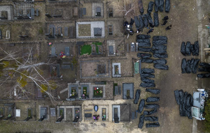 Policemen work to identify civilians who were killed during the Russian occupation in Bucha, Ukraine, on the outskirts of Kyiv, before sending the bodies to the morgue, Wednesday, April 6, 20