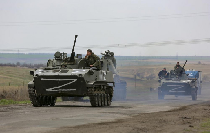 Russian military vehicles move on a highway in an area controlled by Russian-backed separatist forces near Mariupol, Ukraine, Monday, April 18, 2022.