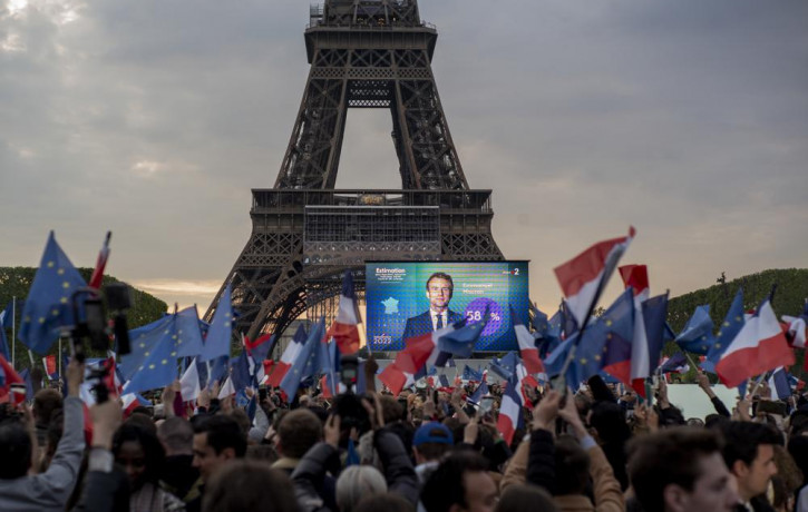 French President Emmanuel Macron celebrates with supporters in front of the Eiffel Tower Paris, France, Sunday, April 24, 2022.