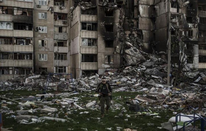 A Ukrainian serviceman walks amid the rubble of a building heavily damaged by multiple Russian bombardments near a frontline in Kharkiv, Ukraine, Monday, April 25, 2022.