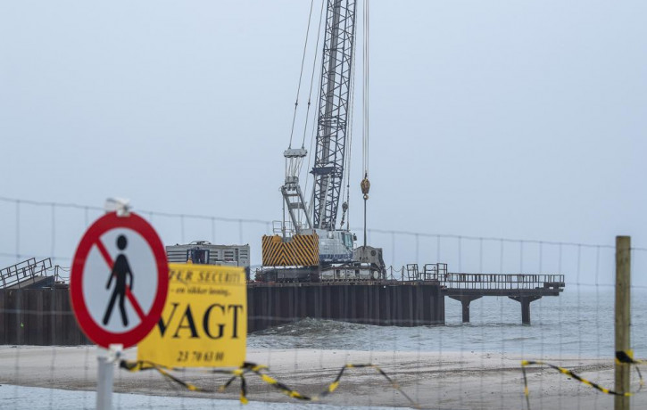 FILE - Construction work on a 200 meter long pier being built where the gas pipeline is due to come ashore at Houstrup Strand, in West Jutland, Denmark, Tuesday Feb. 23, 2021.