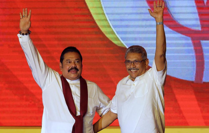 FILE - Mahinda Rajapaksa, left, and his brother Gotabaya Rajapaksa wave to supporters during a party convention held to announce the presidential candidacy in Colombo, Sri Lanka, Aug. 11, 201