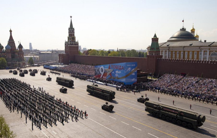FILE - Russian military vehicles roll down Red Square Red Square during a rehearsal for the Victory Day military parade in Moscow, Russia, on May 7, 2019.