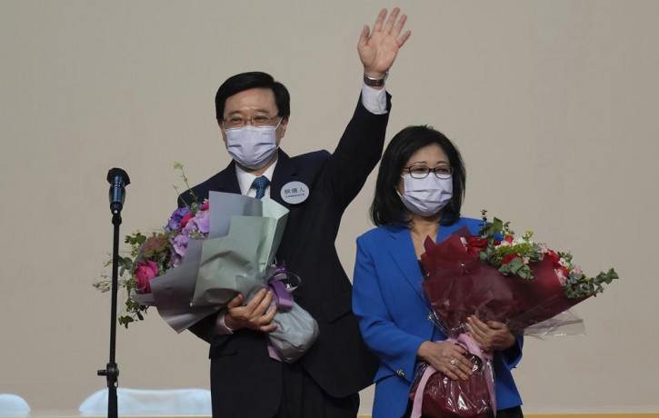 John Lee, former No. 2 official in Hong Kong and the only candidate for the city's top job, celebrates with his wife after declaring his victory in the chief executive election of Hong Kong i