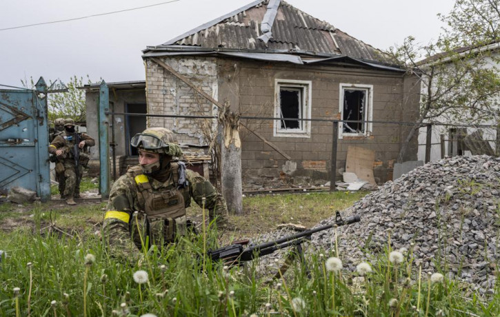 Ukrainian National Guard patrol during a reconnaissance mission in a recently retaken village on the outskirts of Kharkiv, east Ukraine, Saturday, May 14, 2022.