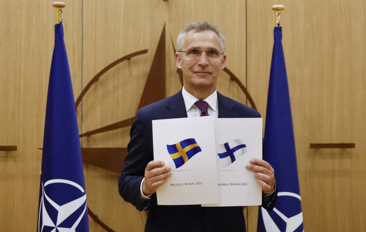 NATO Secretary-General Jens Stoltenberg displays documents as Sweden and Finland applied for membership in Brussels, Belgium, Wednesday May 18, 2022.