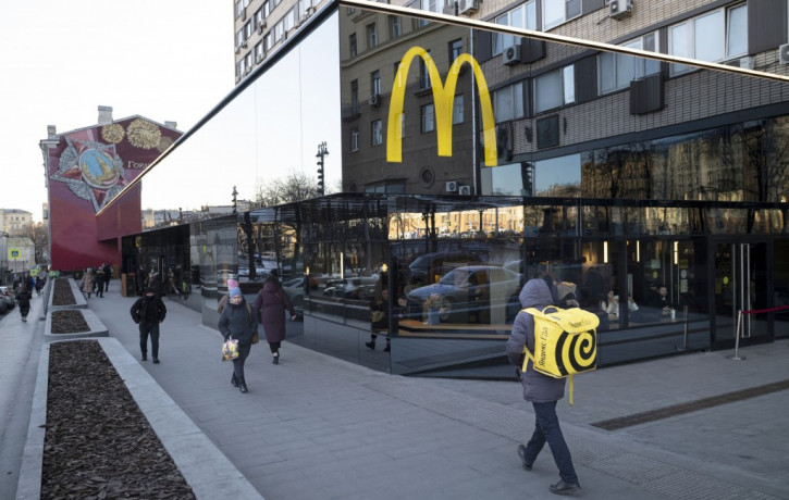 FILE - People walk past a McDonald's restaurant in the main street in Moscow, Russia, Wednesday, March 9, 2022.