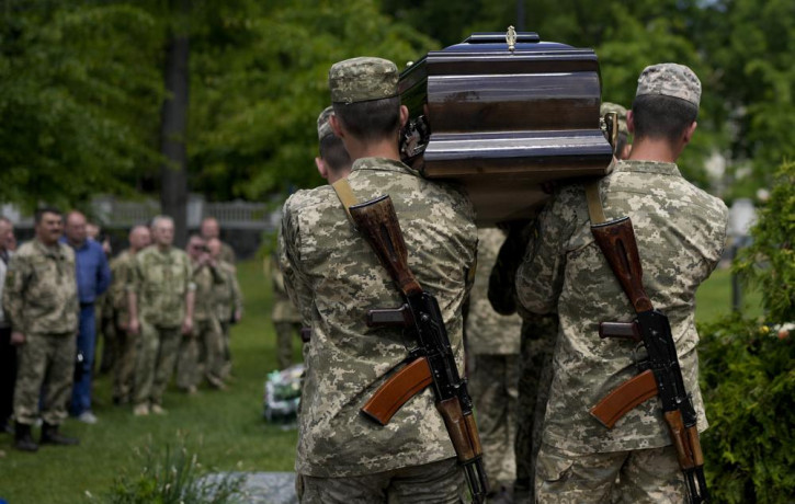 Ukrainian servicemen carry the coffin with the remains of Army Col. Oleksander Makhachek during his funeral in Zhytomyr, Ukraine, Friday, June 3, 2022.