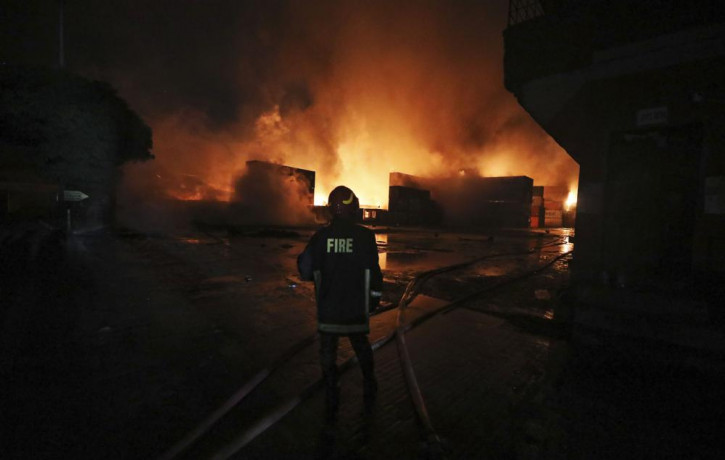 A firefighter works to contain a fire that broke out at the BM Inland Container Depot, a Dutch-Bangladesh joint venture, in Chittagong, 216 km southeast of capital, Dhaka, Bangladesh, early S