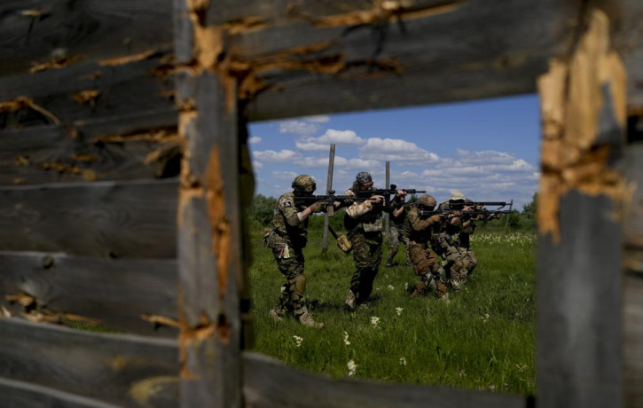 Civilian militia men hold shotguns during training at a shooting range in outskirts Kyiv, Ukraine, Tuesday, June 7, 2022.
