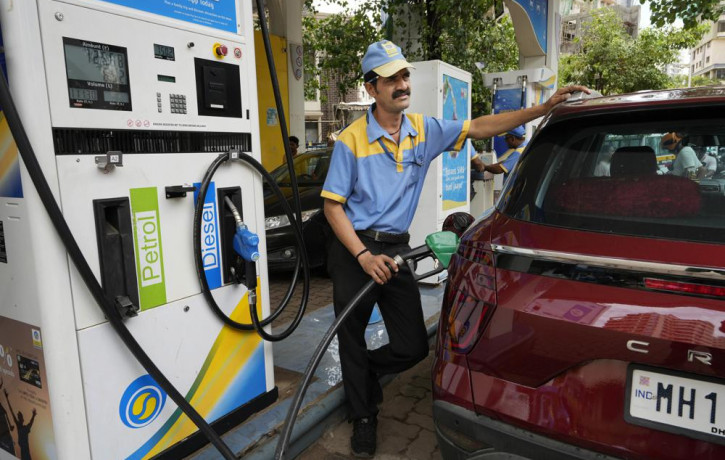 An employee of a Bharat petroleum fuel station fills petrol in a vehicle in Mumbai, India, Saturday, June 11, 2022.