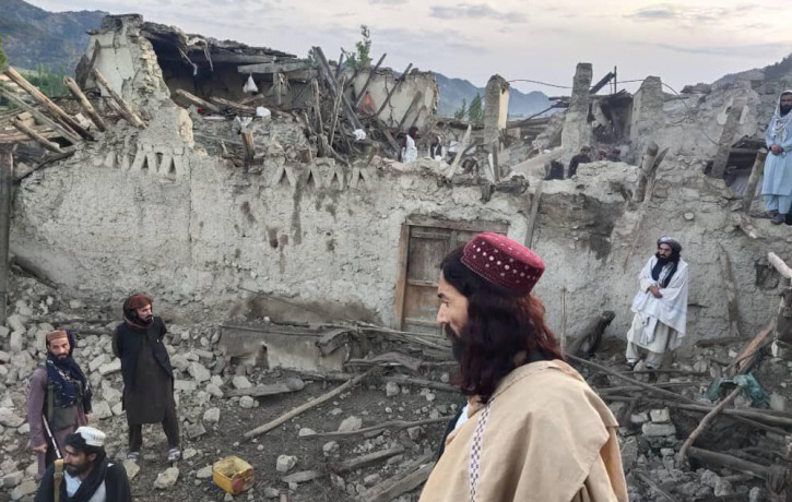 In this photo released by a state-run news agency Bakhtar, Afghans look at destruction caused by an earthquake in the province of Paktika, eastern Afghanistan, Wednesday, June 22, 2022. (Bakh