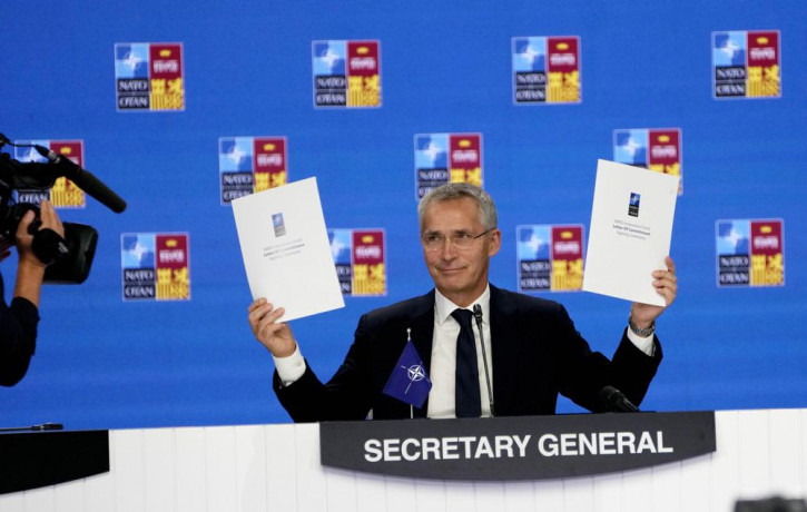 NATO Secretary General Jens Stoltenberg holds up a letter of commitment to innovation at a NATO summit in Madrid, Spain on Thursday, June 30, 2022. AP/RSS Photo